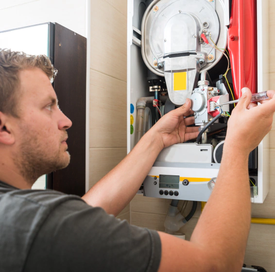 worker repairing gas furnace